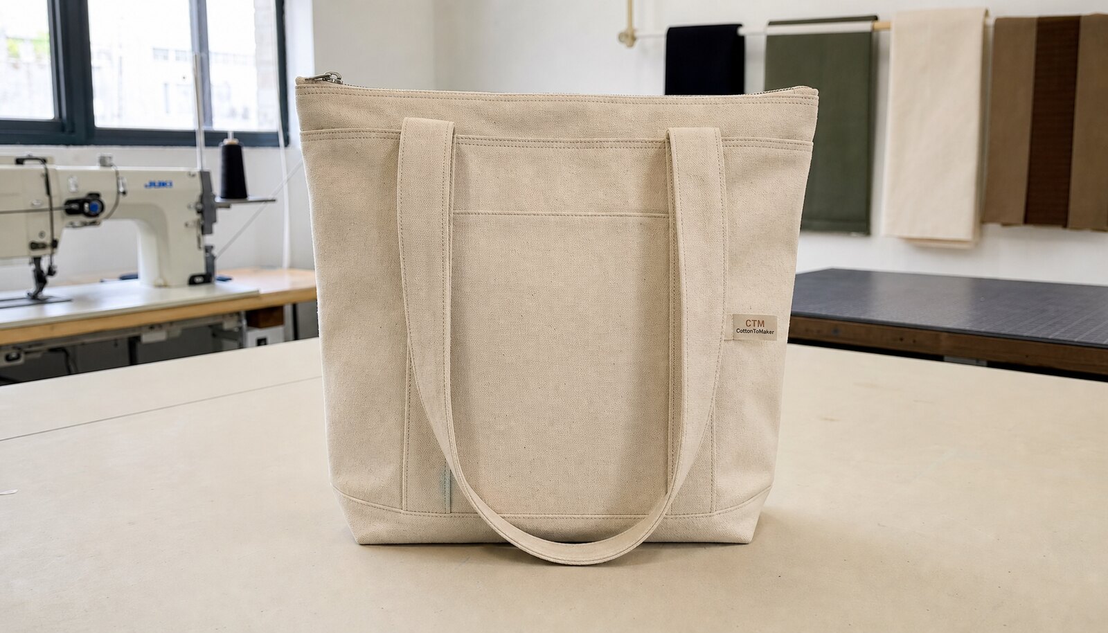 Canvas conference bag sample with a CTM / CottonToMaker side label in a factory sample room