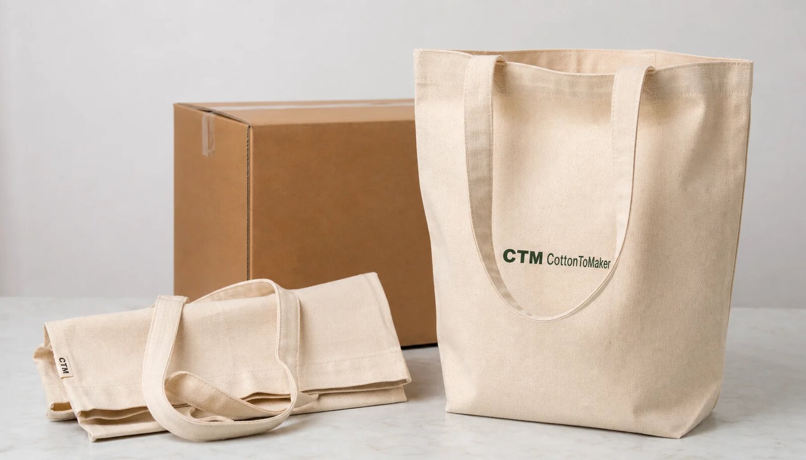 Natural canvas grocery totes with CTM CottonToMaker sample logo beside an export carton