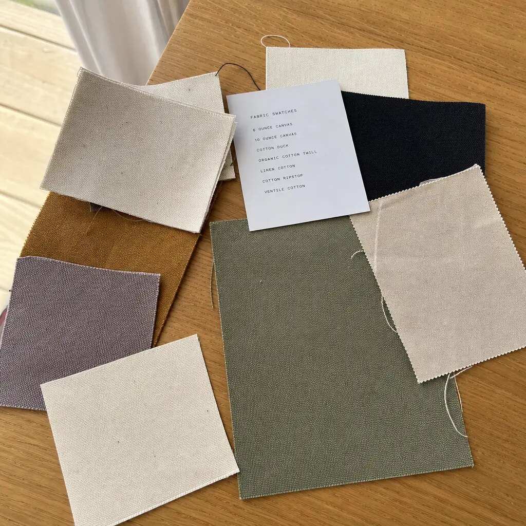 Natural canvas messenger bag with printed CTM CottonToMaker sample logo in a factory proofing room