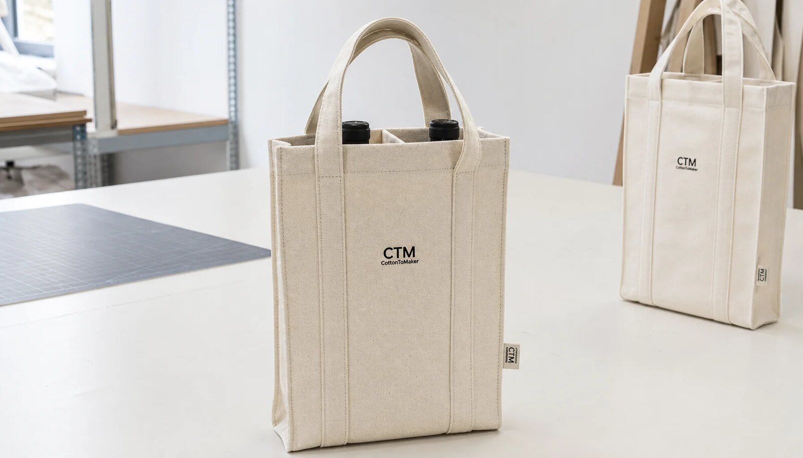 Photorealistic canvas wine carrier with a simple CTM/CottonToMaker logo printed on the front and a woven side label.