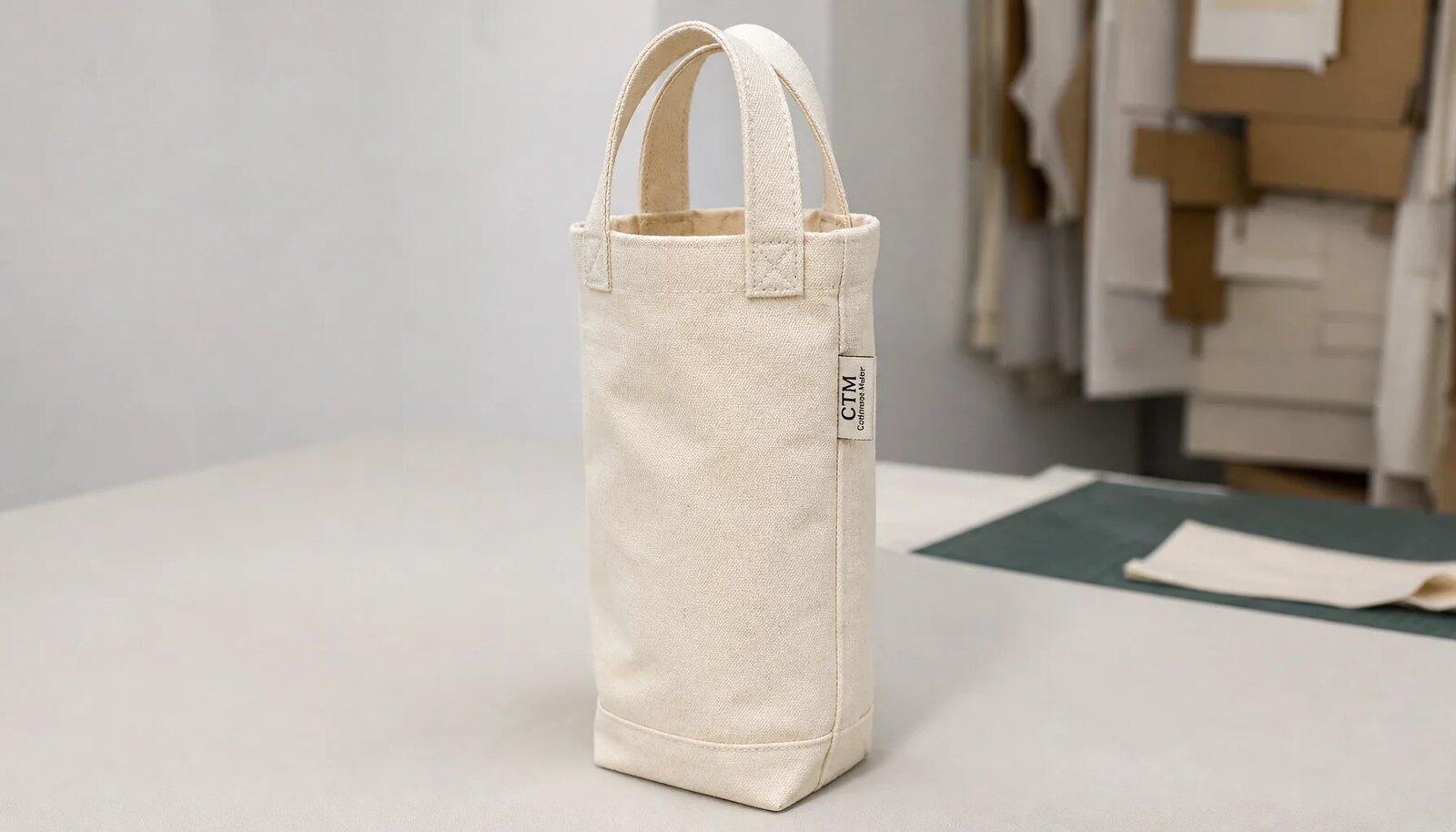 Natural canvas wine carrier with CTM side label in a factory sample room
