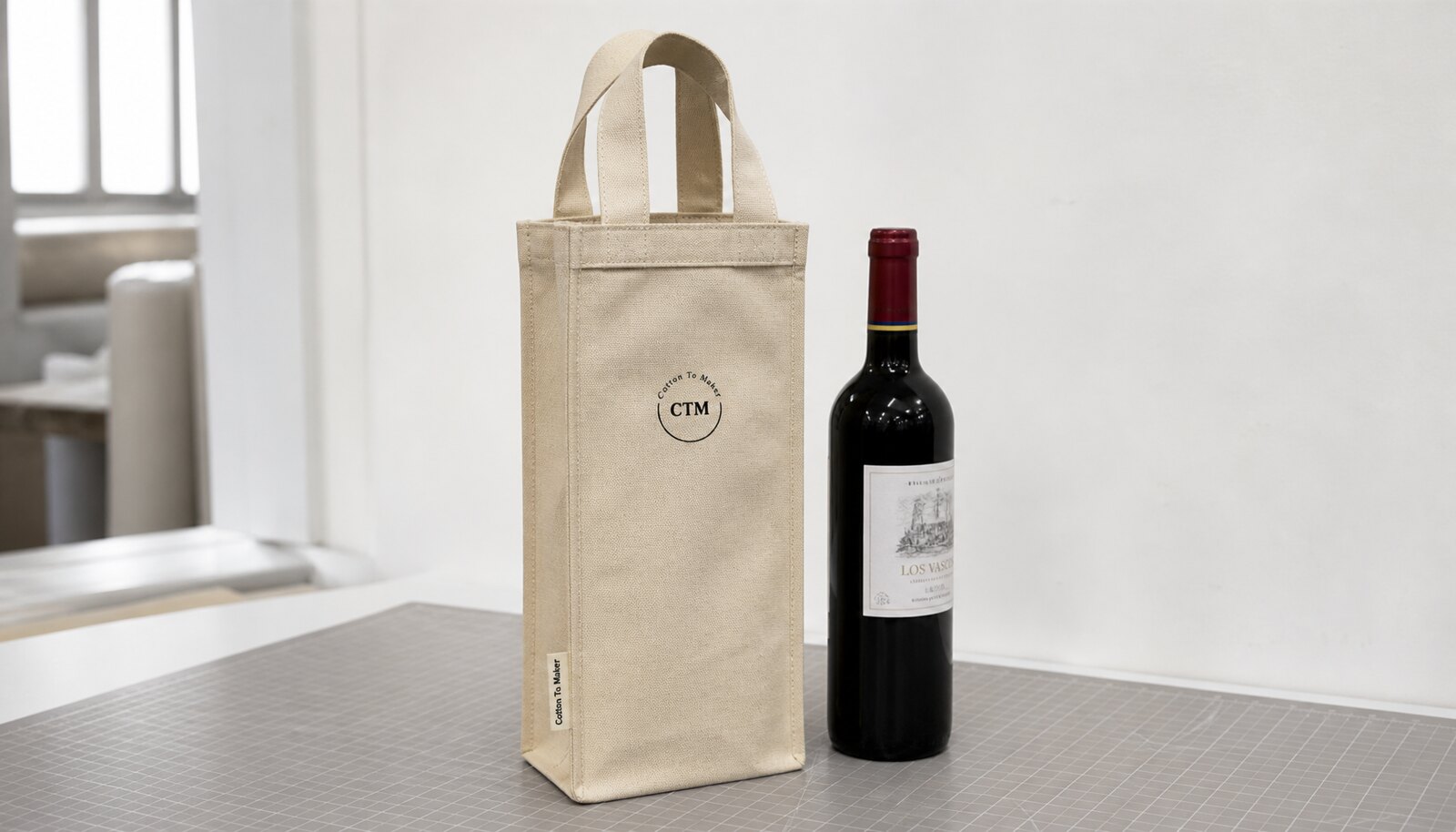 Natural canvas wine carrier with printed CTM sample logo and reinforced handles