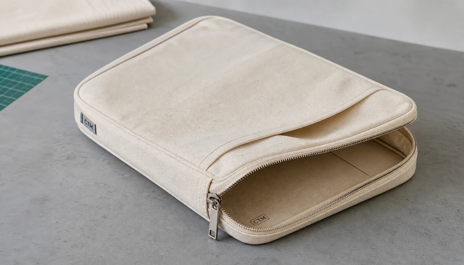 Natural canvas zipper portfolios with CTM sample logo and woven CottonToMaker side label for hotel retail sourcing