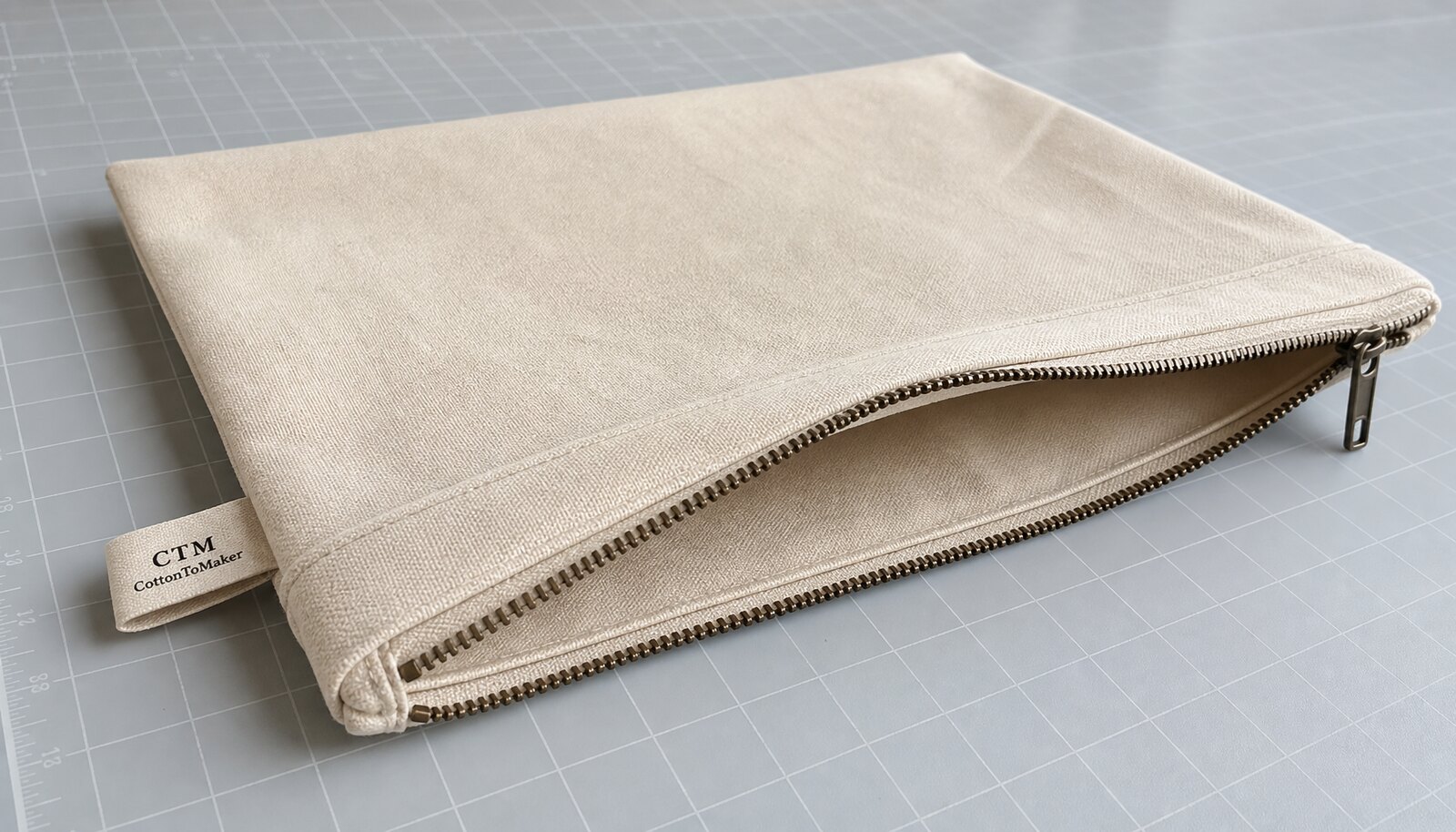 Canvas zipper portfolio with a sewn CTM/CottonToMaker side label photographed in a clean factory sample room