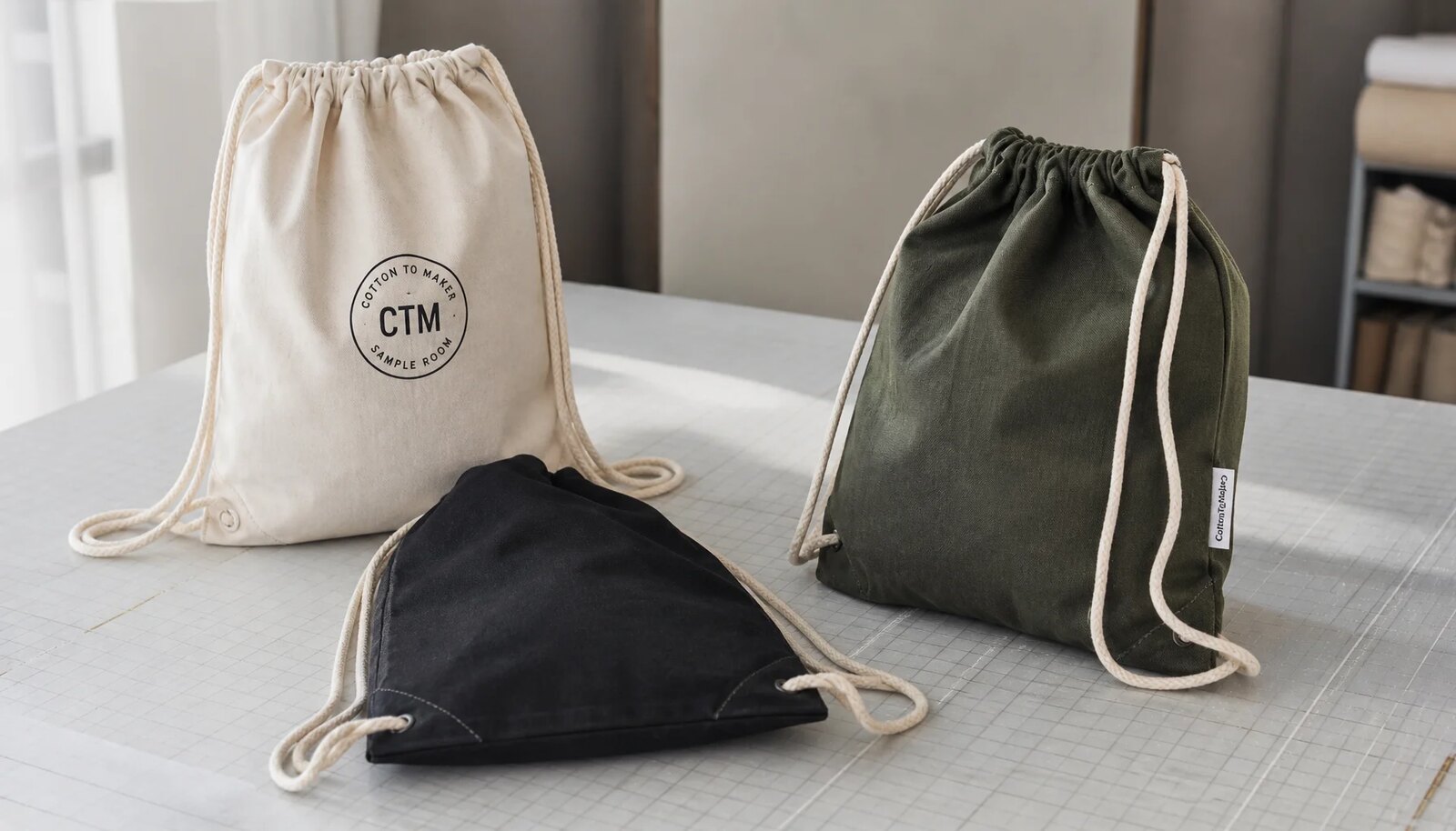 Cotton drawstring backpacks in multiple fabric weights with reinforced corners and printed sample logo