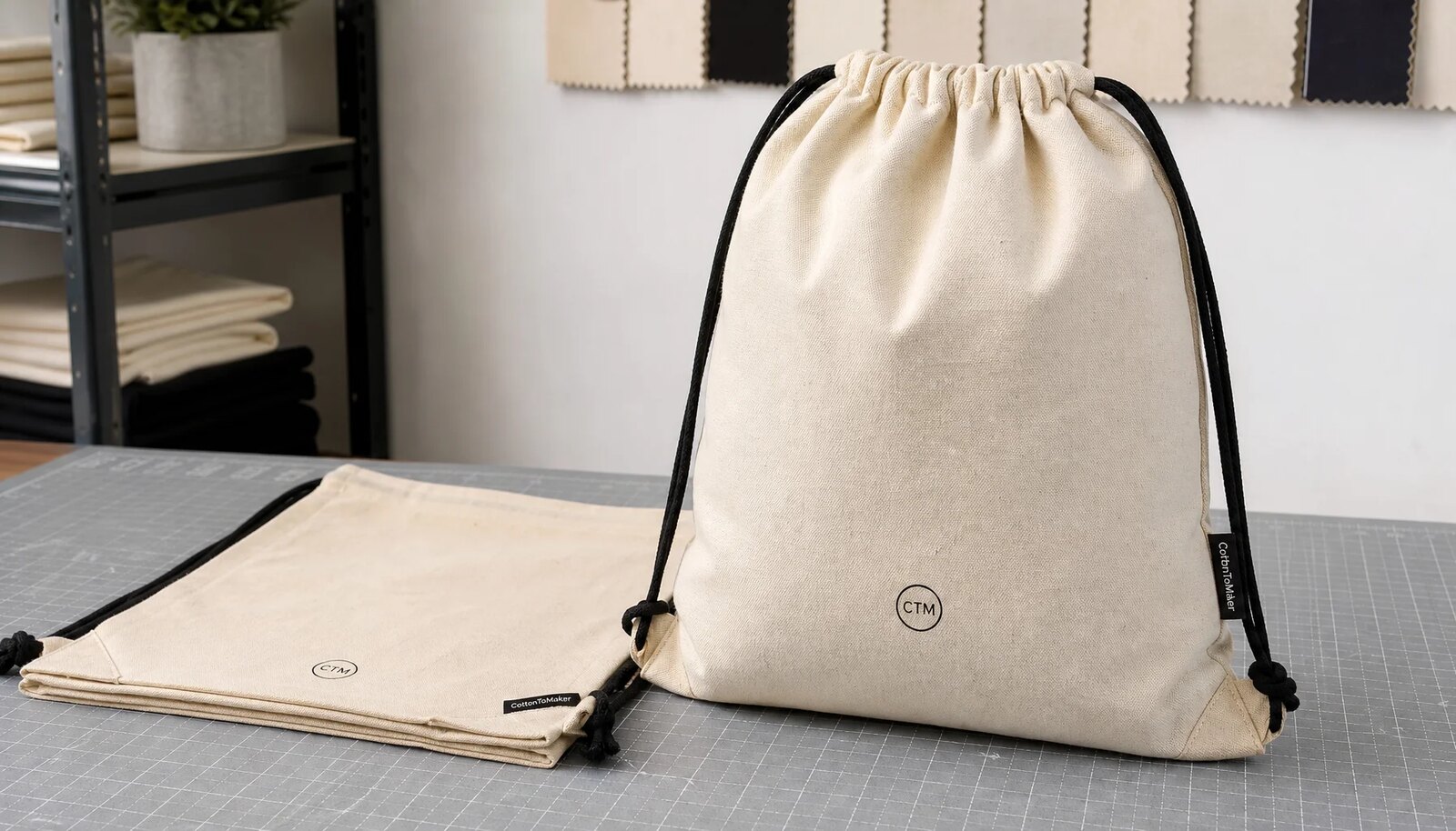 Natural cotton drawstring backpacks with CTM logo sample print on a clean studio table