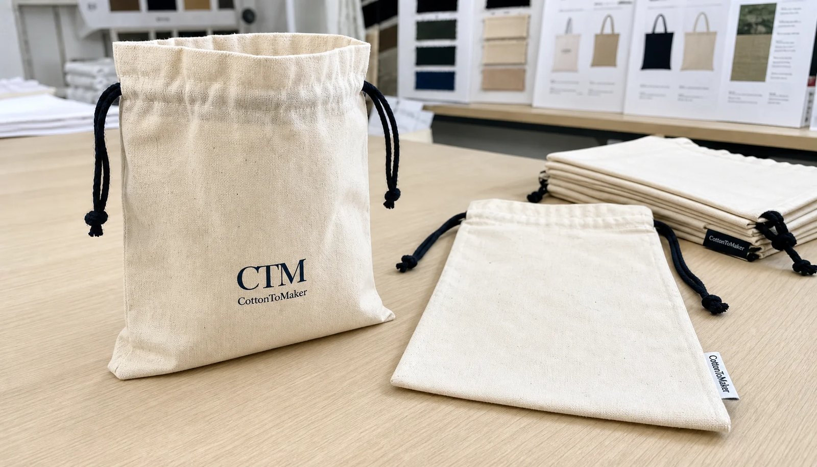 Cotton drawstring pouches with CTM sample logo and print proof sheets for university bookstore sourcing