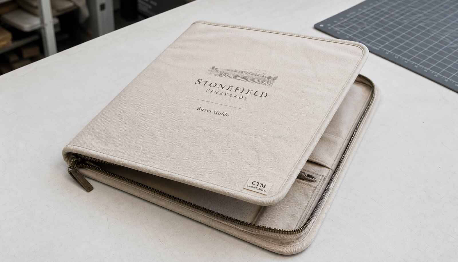 Custom canvas zipper portfolio with a simple CTM sample logo in a clean sample room