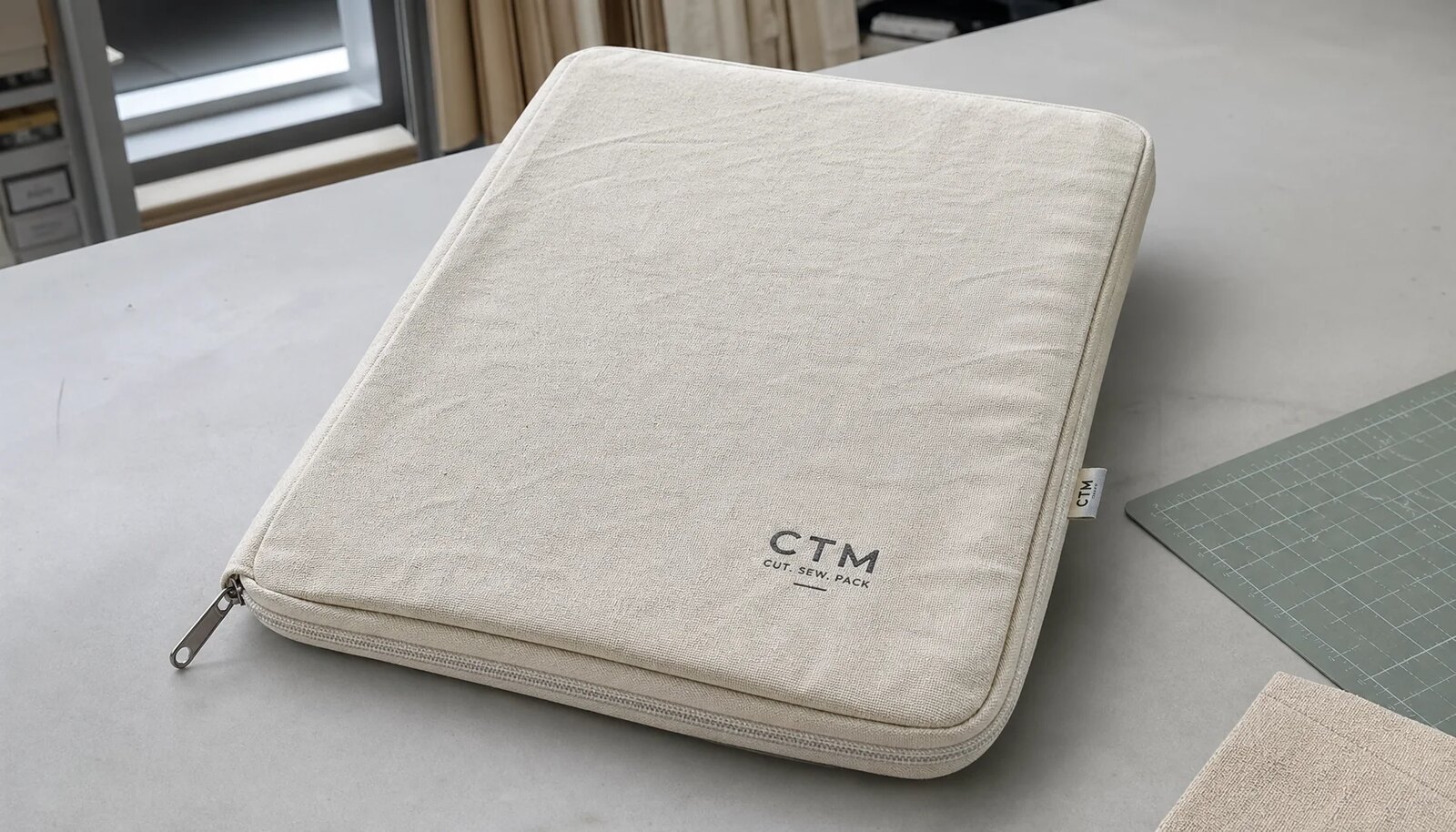 Custom canvas zipper portfolio in natural canvas with printed logo and clean zipper finishing
