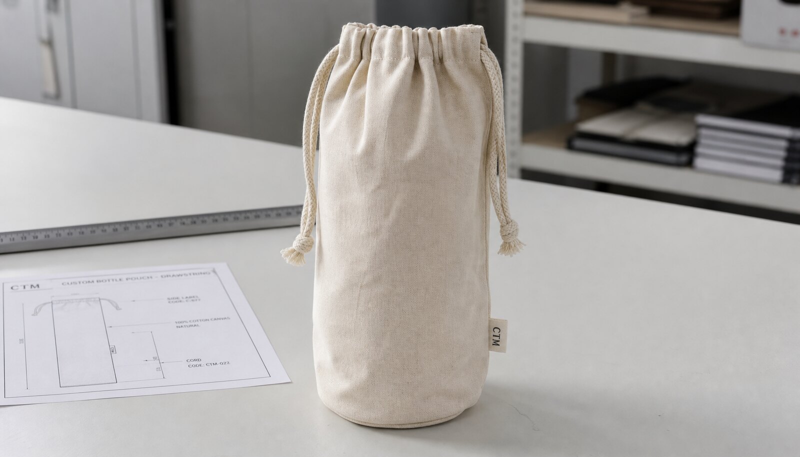 Photorealistic cotton drawstring pouch with a small CTM woven label in a clean factory sample room