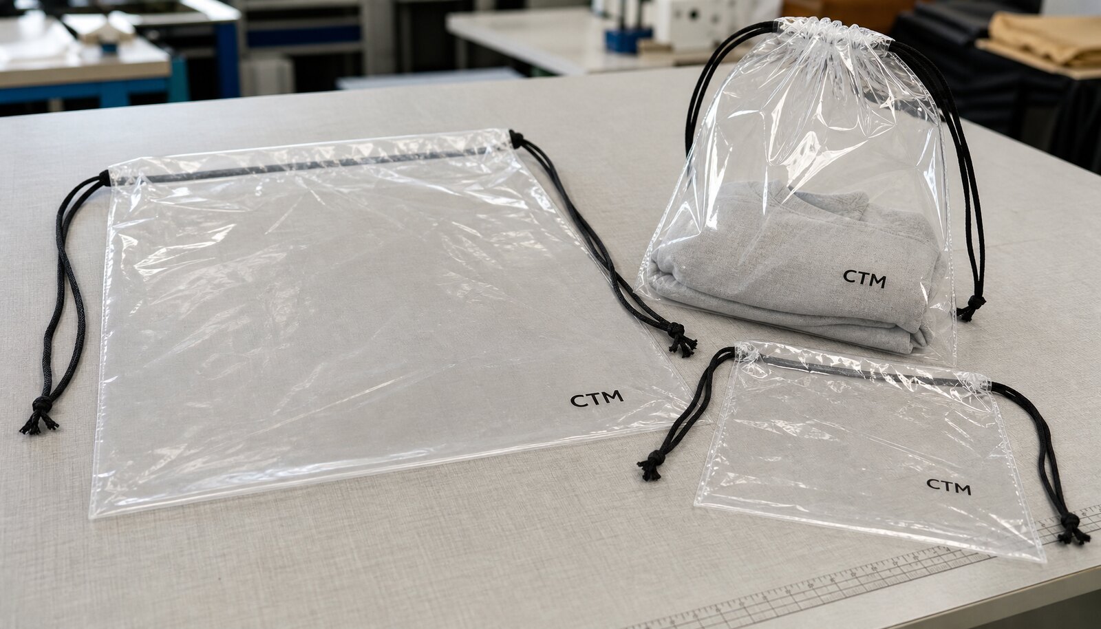 Clear custom plastic drawstring bags with a simple one-color logo in a clean factory sample room