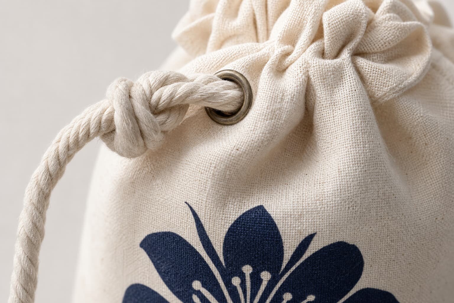 Cotton drawstring pouches with CTM sample logo and woven side label on a clean studio table