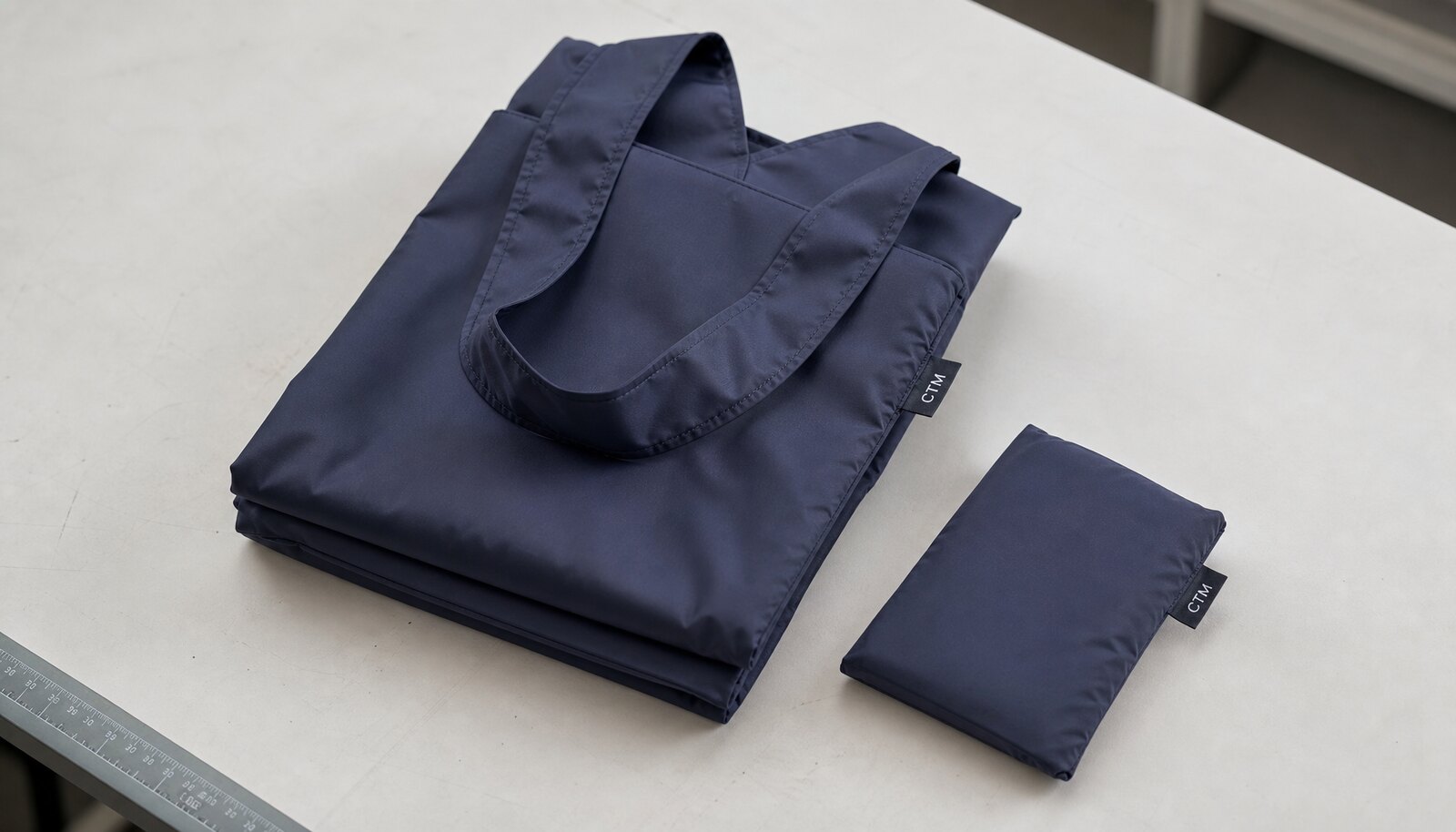 Foldable shopping bag for retail with a simple CTM logo shown in a clean studio setting