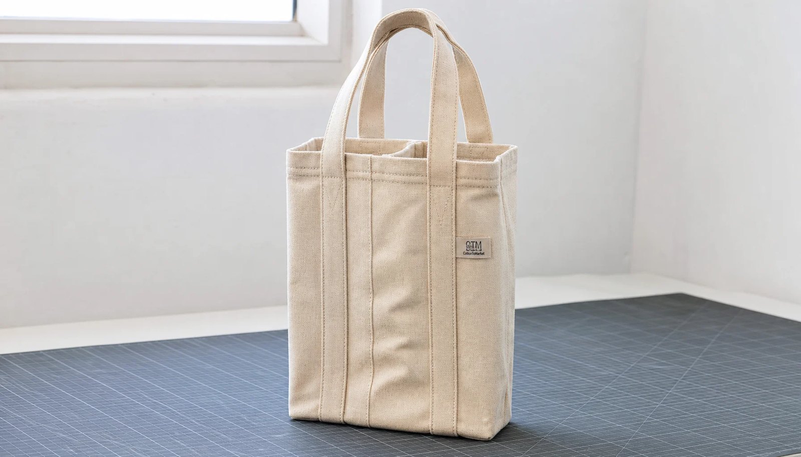 Canvas wine carrier with CTM side label in a factory sample room