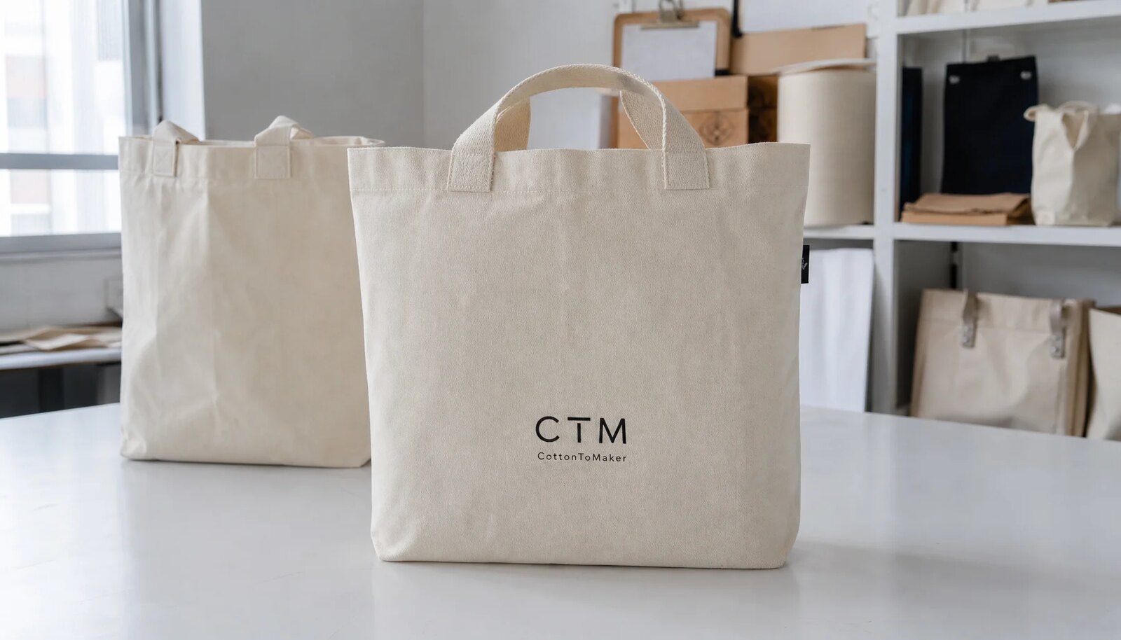 Natural canvas grocery tote with CTM CottonToMaker sample logo printed on the front panel