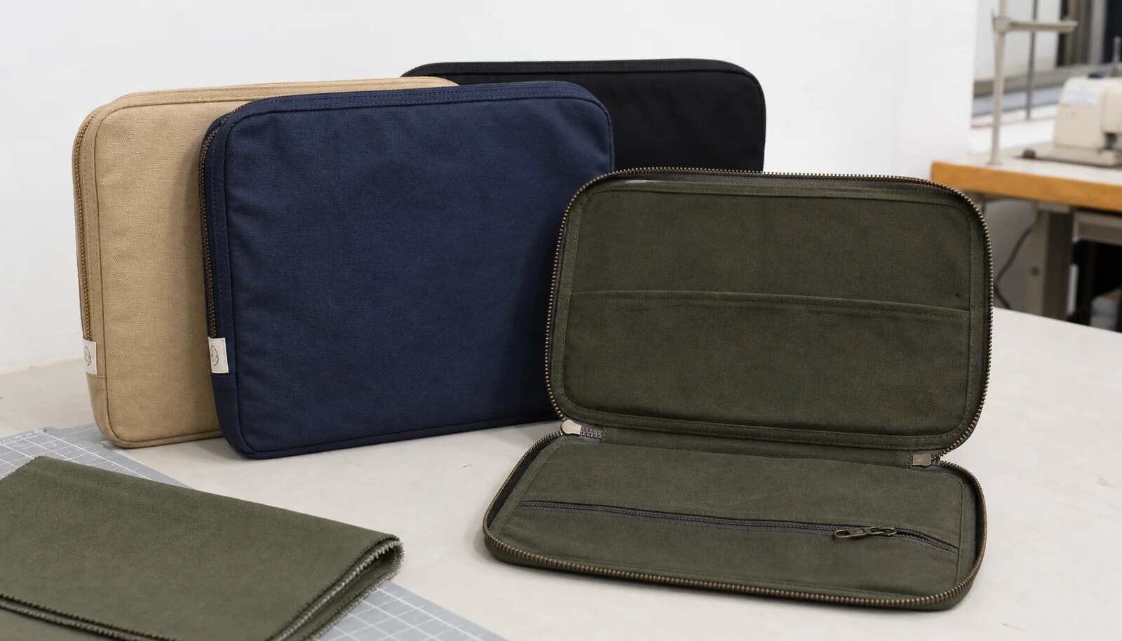 Canvas zipper portfolio with a small CTM woven side label photographed in a clean studio sample setup.