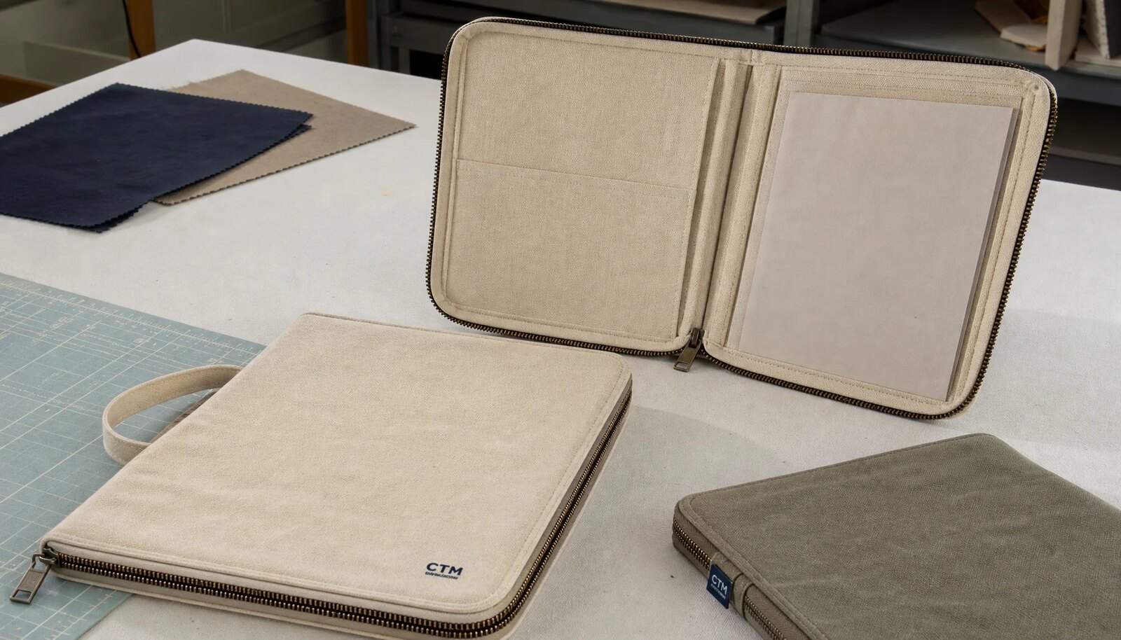 Canvas zipper portfolios with CTM sample logo showing zipper, stitching, and document storage details