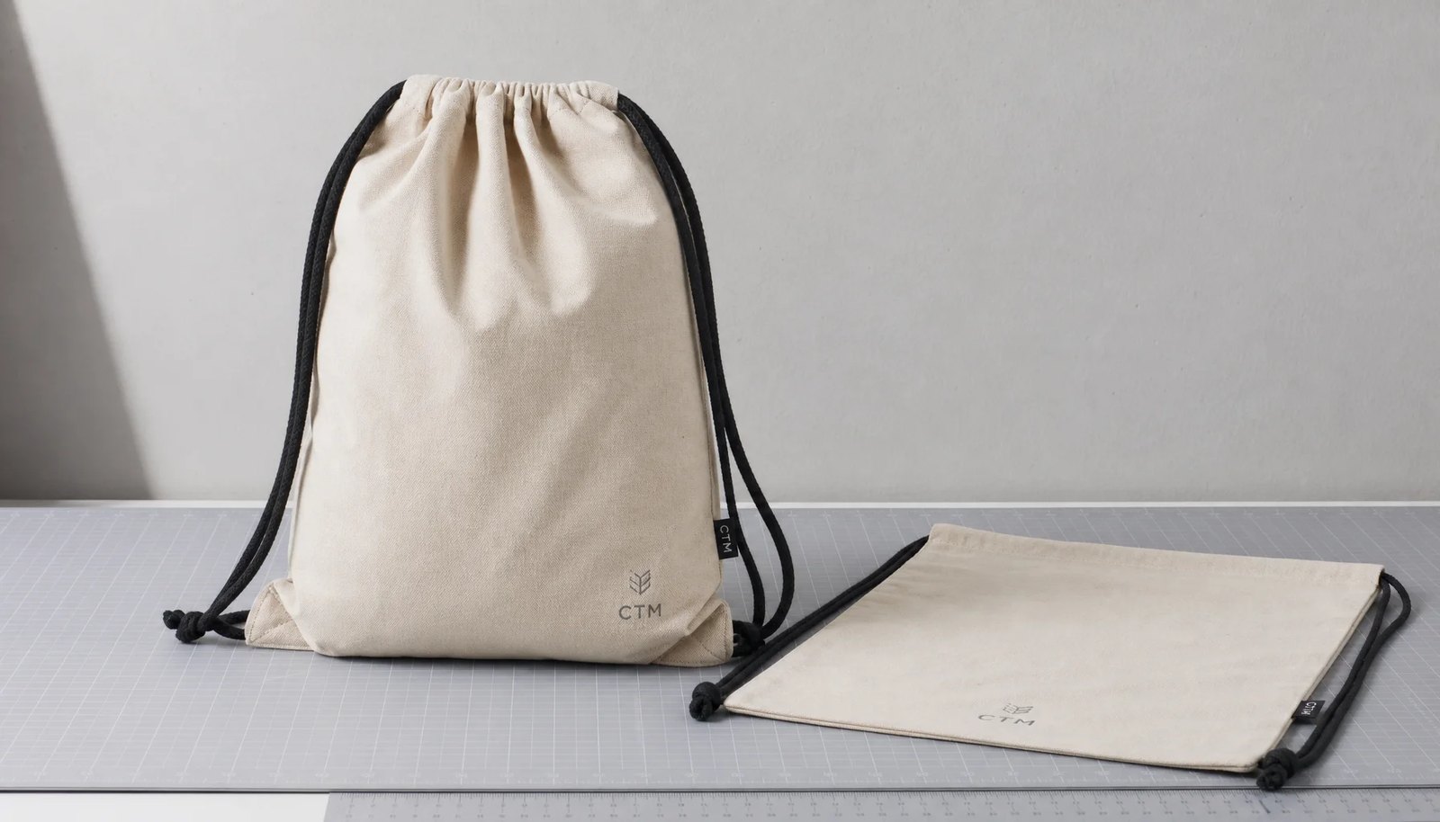 Natural cotton drawstring backpack sample with CTM logo and CottonToMaker side label