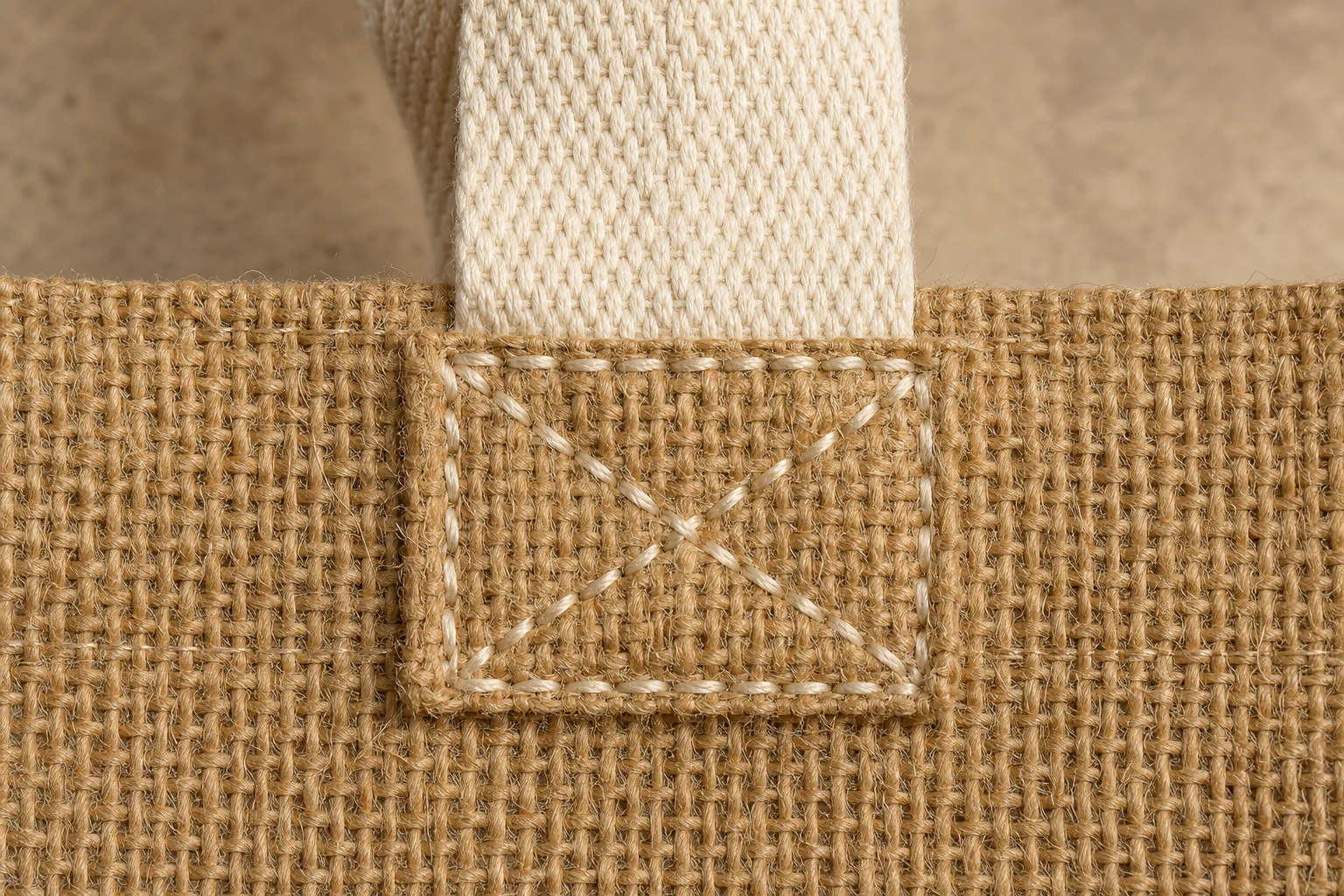 Coarse jute weave and reinforced cotton handle stitching detail