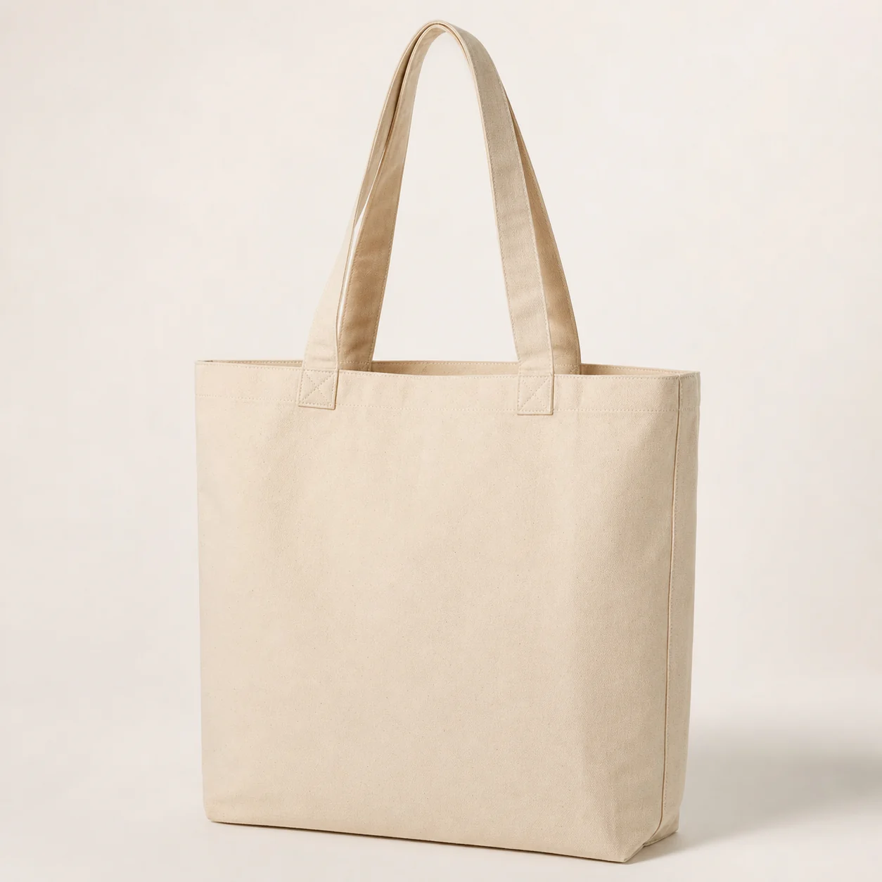 Blank heavyweight natural canvas tote bag on a white studio background